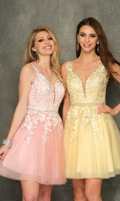 Two women stand side by side, one wearing the A-Line Short Homecoming Dress H341 with a beaded bodice and the other in a short yellow lace dress, both smiling in front of a gray backdrop.