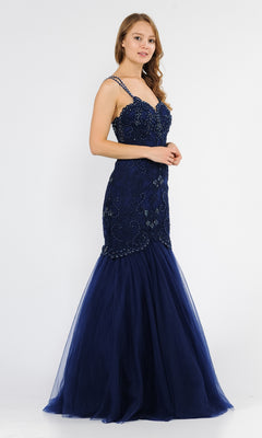 Woman wearing the Embroidered Tight Sweetheart Mermaid Prom Dress 8352, a navy blue, floor-length gown with bead embellishments and spaghetti straps, standing against a plain white background.