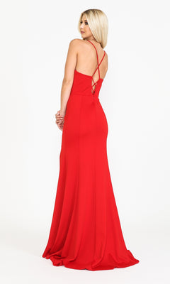 A woman stands facing away, wearing the Open-Back V-Neck Long Simple Jersey Prom Dress 8360 in red, featuring thin crisscross straps over an exposed back.