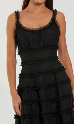 Woman wearing the Mac Duggal 8372 Floral Lace Long Formal Dress, featuring a sleeveless design, scoop neckline, and textured ruffle details, standing against a plain light background.