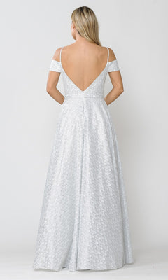 A woman with long blonde hair models the Cold-Shoulder Silver and White Long Prom Gown 8380, showcasing its floor-length, off-the-shoulder design and deep V-back as she stands facing away from the camera against a plain background.