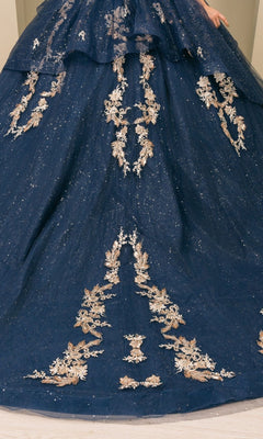 A stunning navy blue quinceanera ball gown, Quinceanera Dress 8390JQ by Cinderella Couture, features gold floral embroidery cascading down the skirt and sparkly details, shown from the waist down.