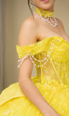 Person wearing a bright yellow Quinceanera Dress 8415JQ By Cinderella Couture, featuring off the shoulder design, floral embellishments, pearl details, and a matching choker necklace.