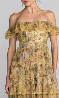 A woman is wearing the Mac Duggal 8418 long formal dress—a yellow floral off-the-shoulder gown featuring ruffles, lace details, and sheer layered fabric. This elegant A-line style showcases charm and sophistication, with only the upper body visible.