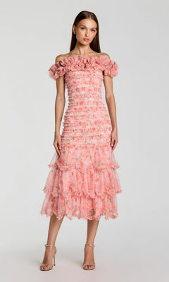 A woman wearing the Midi Party Dress: Mac Duggal 8432—a ruffle tiered, blush multi, off-the-shoulder midi dress—stands against a plain light background.
