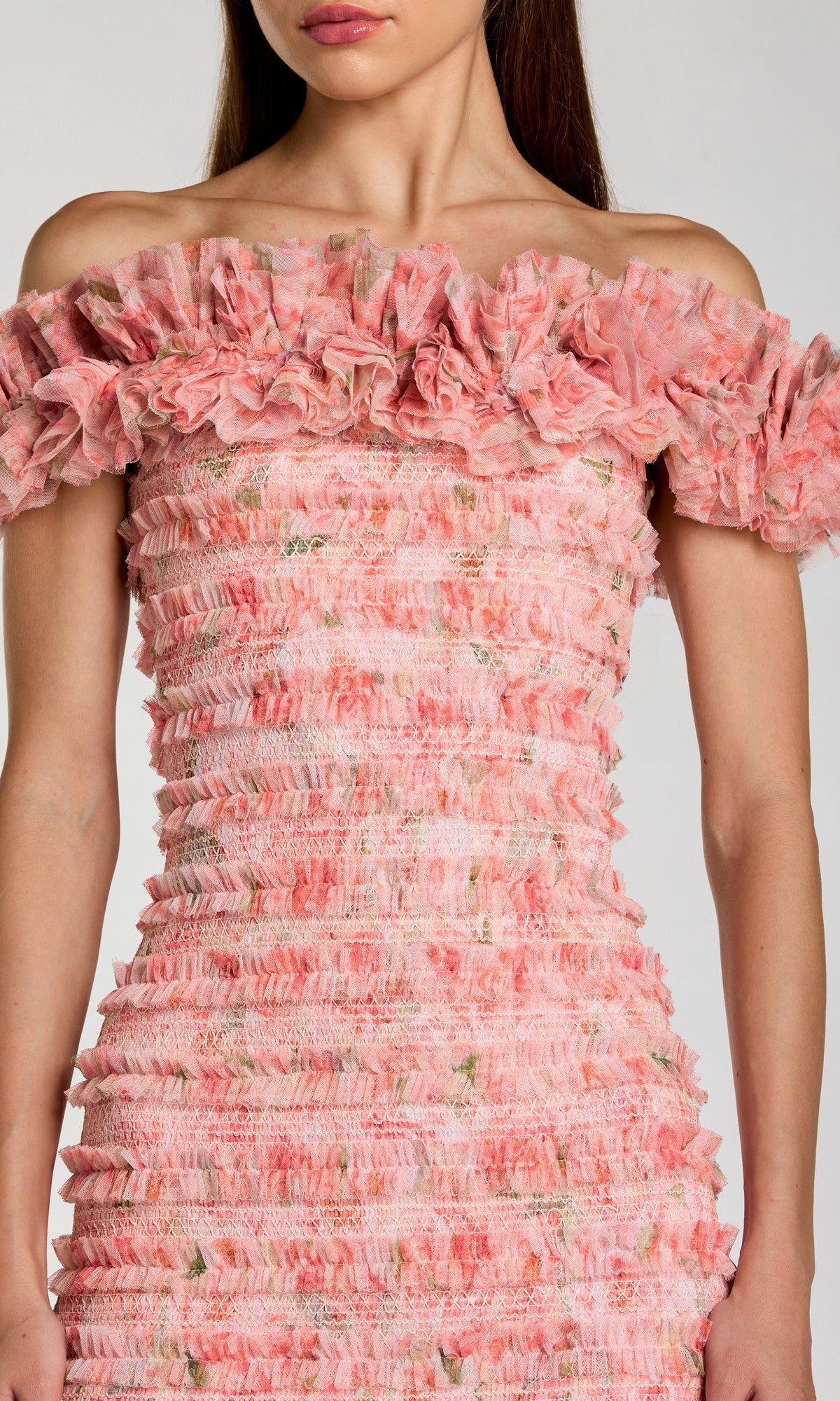 A woman in the Mac Duggal 8432 Midi Party Dress—a beautiful off-the-shoulder pink party dress adorned with ruffle tiered layers and a delicate floral pattern, making it the perfect pink floral midi dress for special occasions.