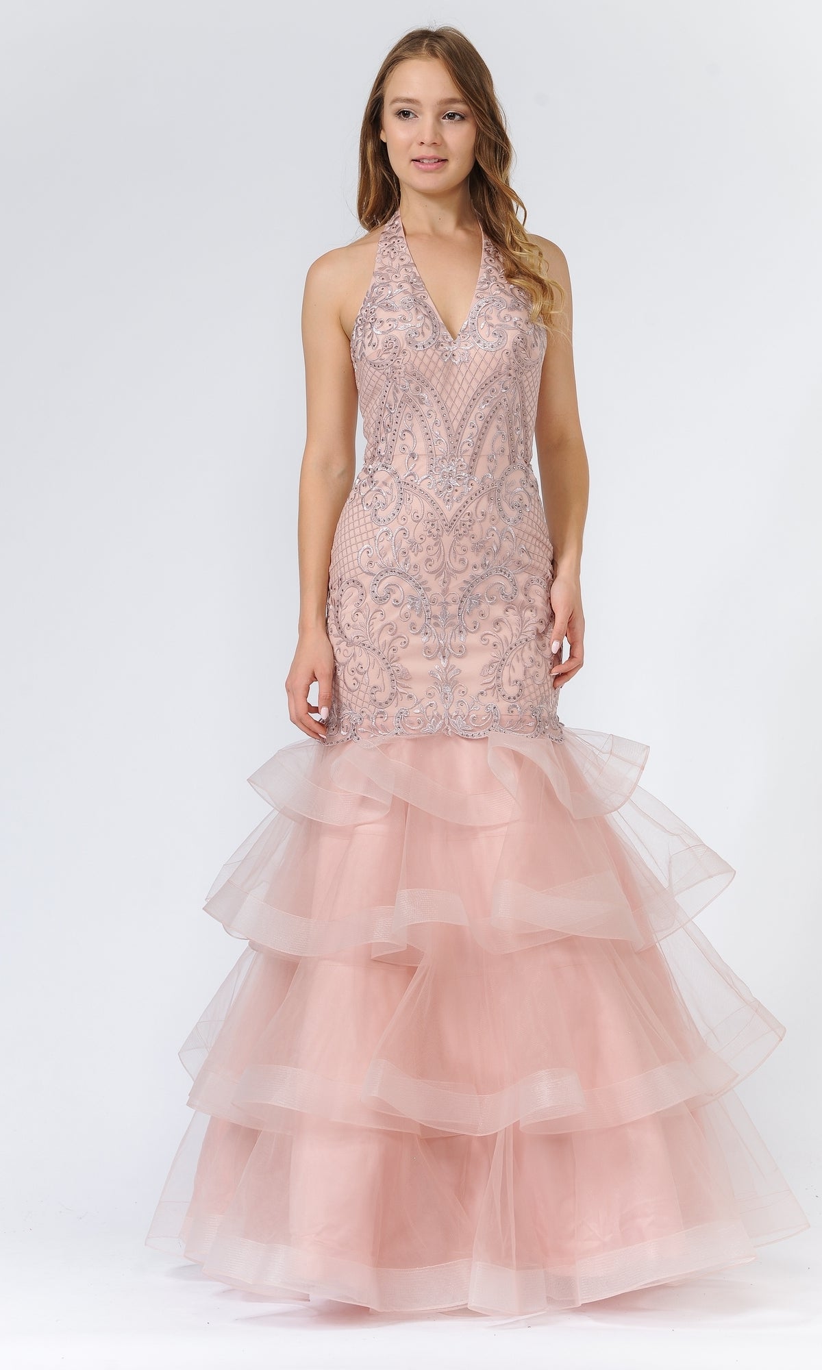 A woman wears the Beaded Long Halter Mermaid Tiered Prom Dress 8466 in mauve, featuring intricate beadwork on the bodice, a sleeveless halter neckline, and layered tulle ruffles on the skirt.