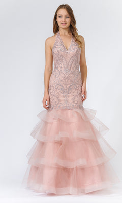 A woman wears the Beaded Long Halter Mermaid Tiered Prom Dress 8466 in mauve, featuring intricate beadwork on the bodice, a sleeveless halter neckline, and layered tulle ruffles on the skirt.