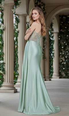 A woman in the Cinderella Couture 8483J long, light green satin prom dress with a sheer corset bodice and thin straps stands in a colonnaded garden, looking over her shoulder.