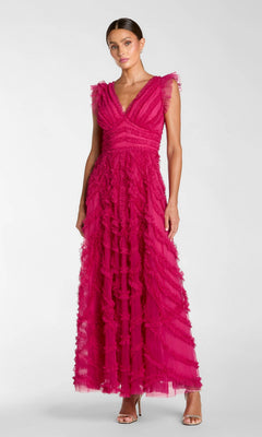 A woman stands in heels against a plain background wearing the Mac Duggal 8498 long formal dress in fuchsia—a sleeveless, floor-length gown featuring ruffled tulle details and an elegant A-line silhouette.