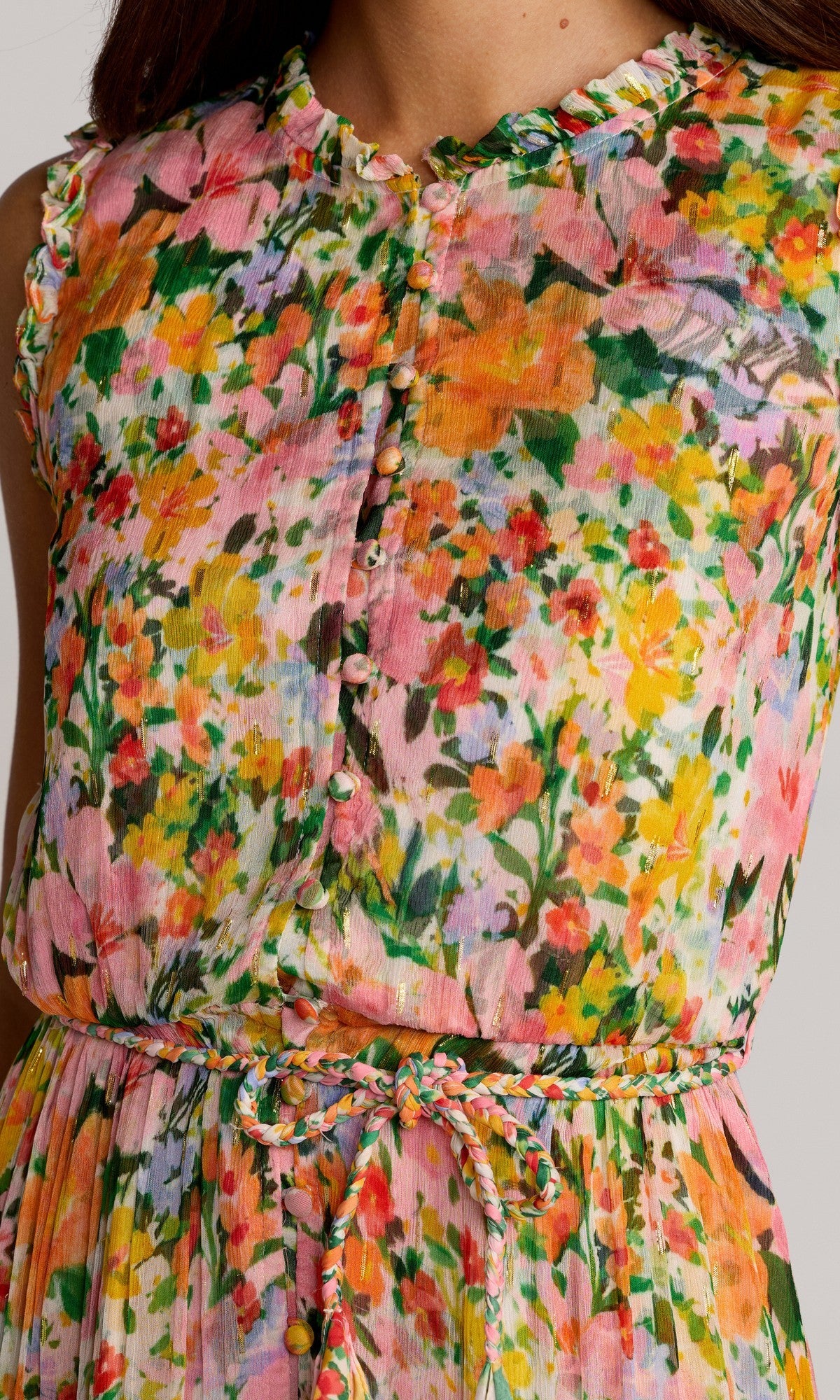 A close-up of the Mac Duggal 8500 Tea-Length Party Dress, featuring a colorful floral pattern, fabric-covered buttons, a braided waist tie, and a sleeveless design.