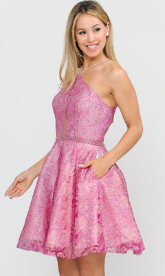Woman in the Glitter-Mesh Short A-Line Homecoming Dress 8506 in Magenta/Blush, sleeveless with a sheer bodice panel, stands sideways, smiling with one hand in her pocket.