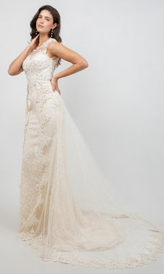 A woman poses sideways against a plain light background, wearing the Long Formal Dress: Cinderella Couture 8506J—an ivory lace wedding gown featuring a long tulle train and delicate lace appliqués.