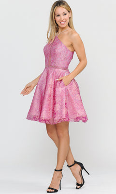 A woman wearing the Glitter-Mesh Short A-Line Homecoming Dress 8506, a sleeveless pink lace dress with side pockets, paired with black high-heeled sandals, stands against a plain light background.
