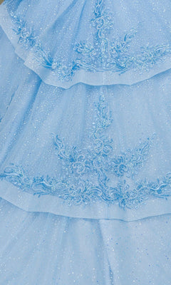 Close-up of a light blue, sparkly fabric with embroidered floral patterns and layered ruffles, reminiscent of the dazzling Quinceanera Dress 8520JQ by Cinderella Couture.