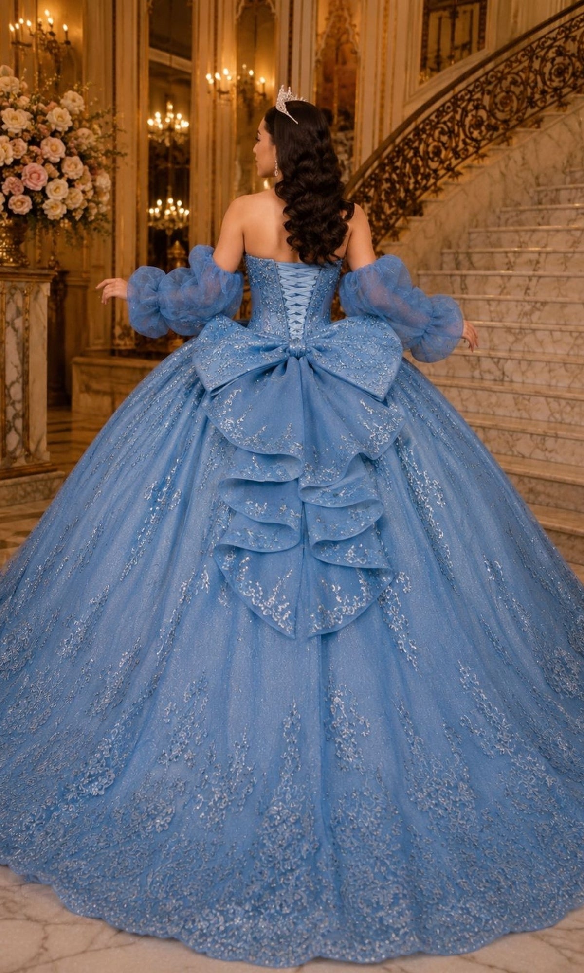 Back view of the Cinderella Couture 8565JQ strapless blue ball gown, featuring removable sheer puff sleeves, a lace-up bodice, and a large back bow.