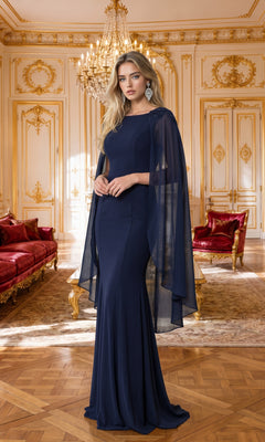 A woman wearing the High-Neck Simple Long Jersey Prom Dress 8566 in navy stands in an ornate, gold-trimmed room adorned with red velvet furniture and a chandelier.
