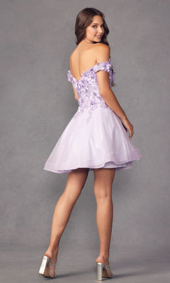 A woman stands against a plain gray background in the Floral Off-the-Shoulder Short Homecoming Dress 861, featuring 3-D flowers and an A-line silhouette, looking over her shoulder in silver high heels.