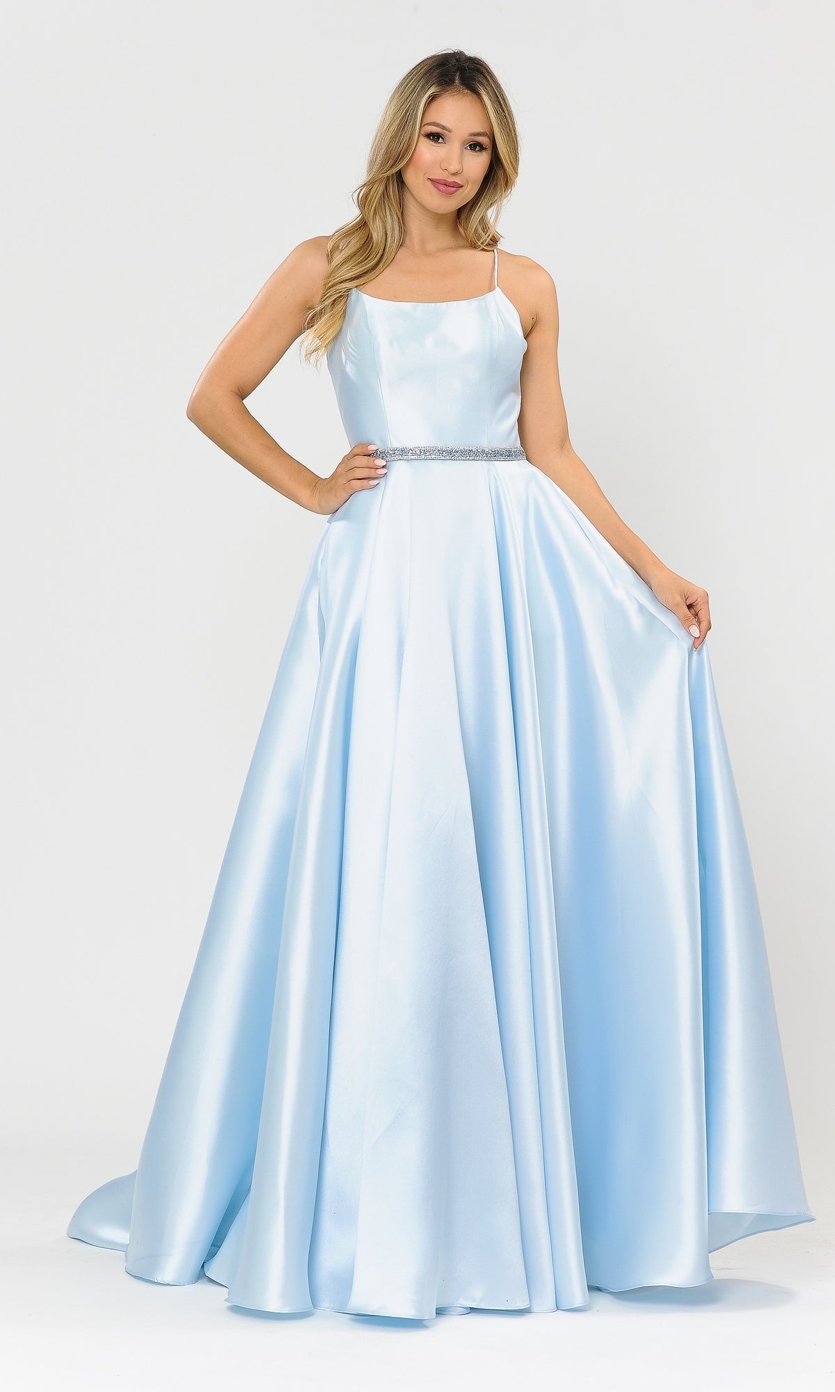 A woman models the Scoop-Neck Long A-Line Prom Dress with Pockets 8684 in blue, featuring a fitted bodice and thin straps, against a white background.