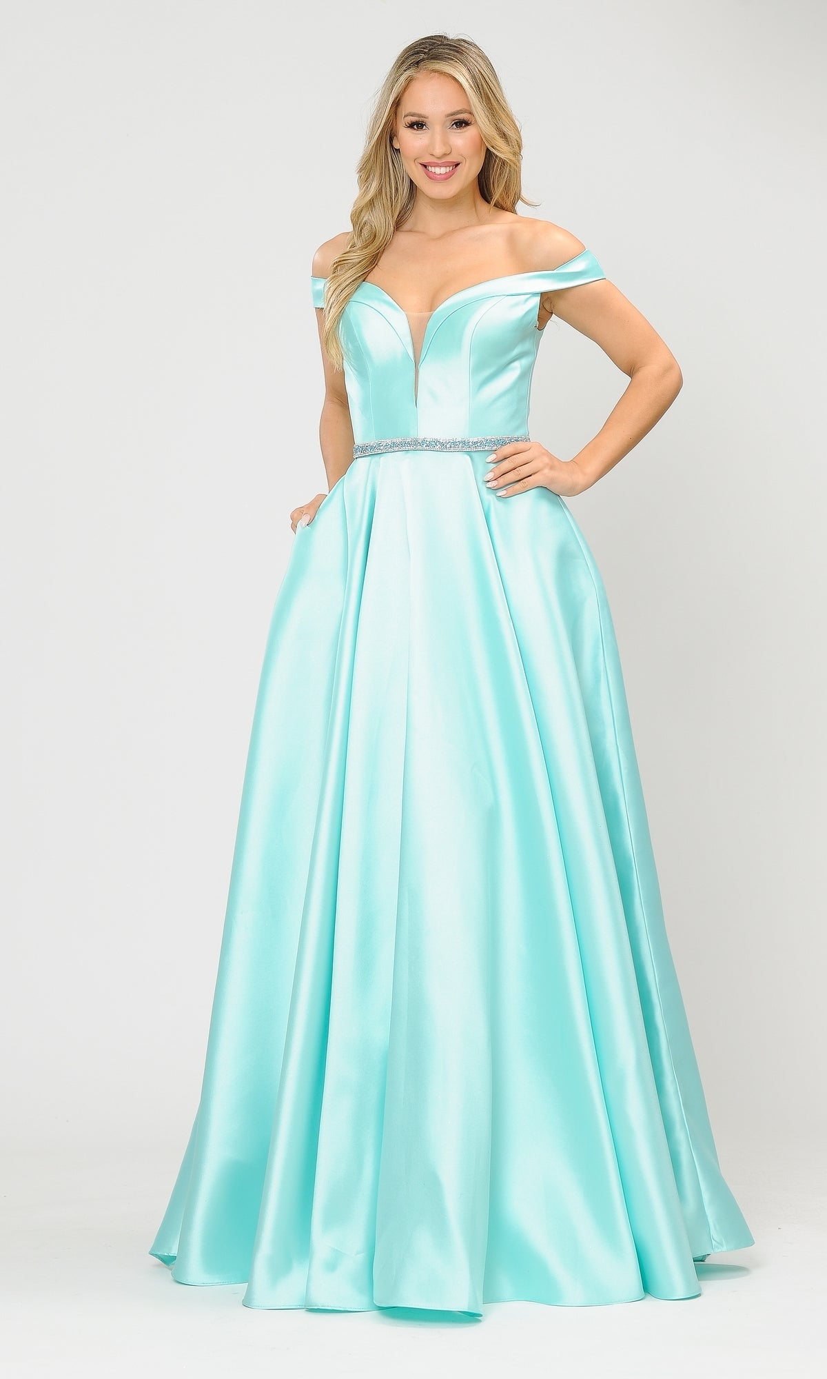 A woman models the Off-the-Shoulder Long Prom Gown with Pockets 8686 in beautiful light blue satin, featuring a fitted bodice, jeweled waistband, and full skirt against a plain white background.