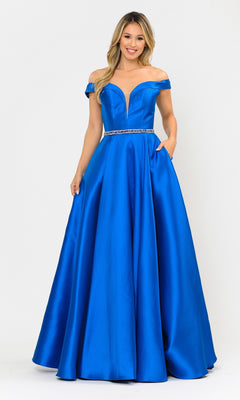 A woman models the Off-the-Shoulder Long Prom Gown with Pockets 8686 in royal blue Mikado, featuring a beaded waist, against a plain white background.