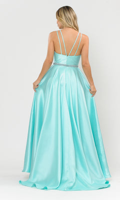 A woman stands facing away, holding the skirt of a light blue Long A-Line Mikado Prom Gown 8690 with pockets and thin crisscross straps, featuring a beaded waistband.