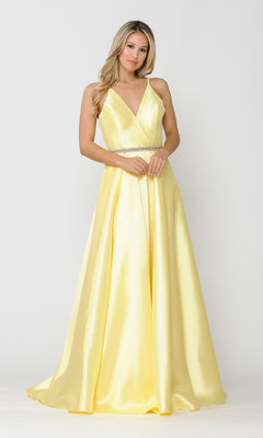 A woman stands against a plain white background wearing the Long A-Line Mikado Prom Gown 8690, a sleeveless yellow evening dress featuring a V-neckline, beaded waist, and pockets.