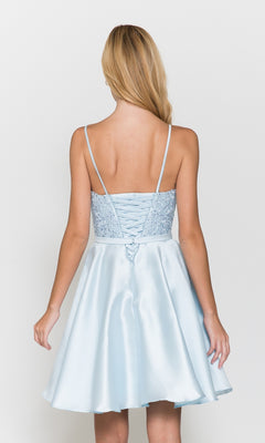 A woman with long blonde hair wears the Short A-Line Homecoming Dress with Pockets 8694, a light blue sleeveless dress featuring a lace-up back, shown against a plain white background.