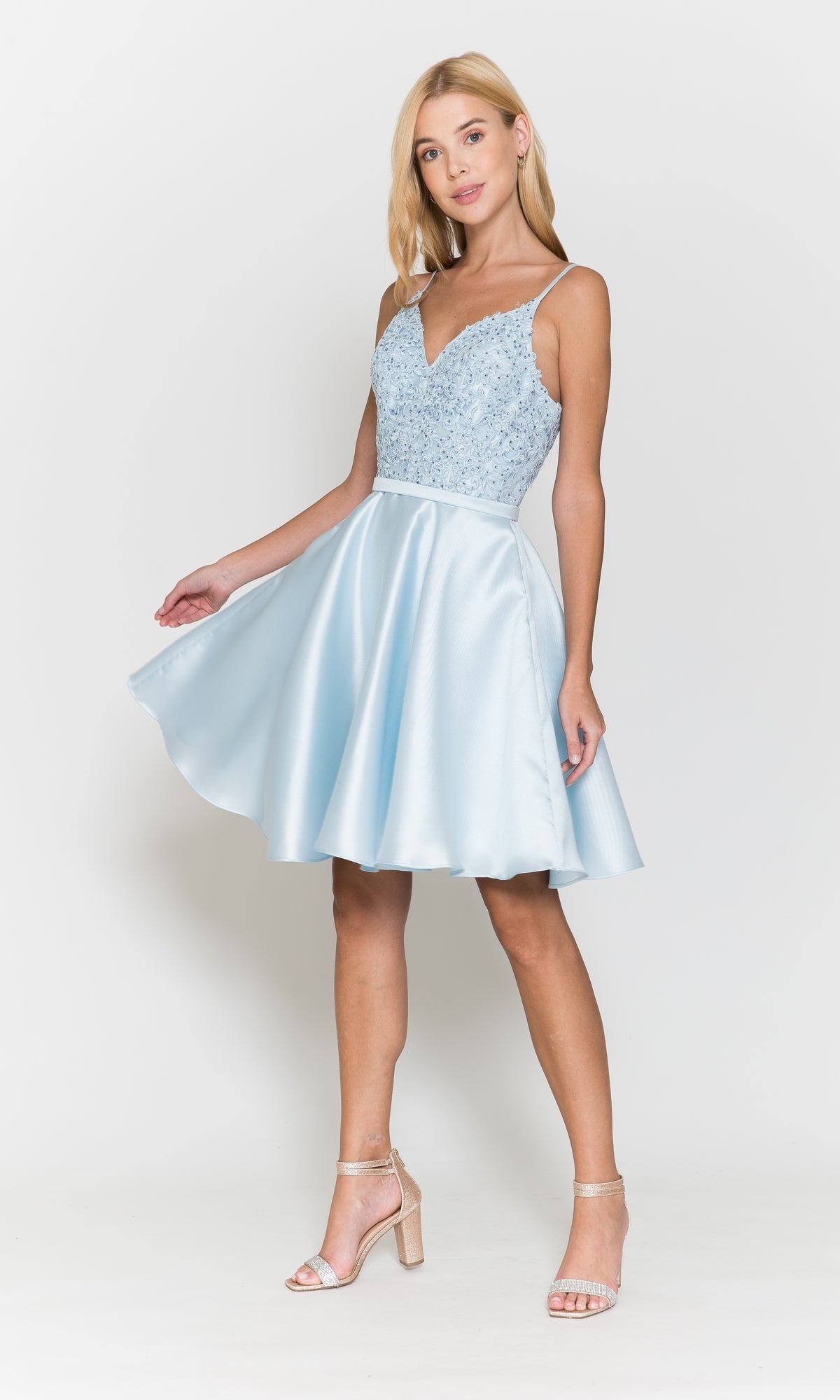 Woman wearing the Short A-Line Homecoming Dress with Pockets 8694, featuring a beaded v-neck bodice and flared skirt, posing against a white background.