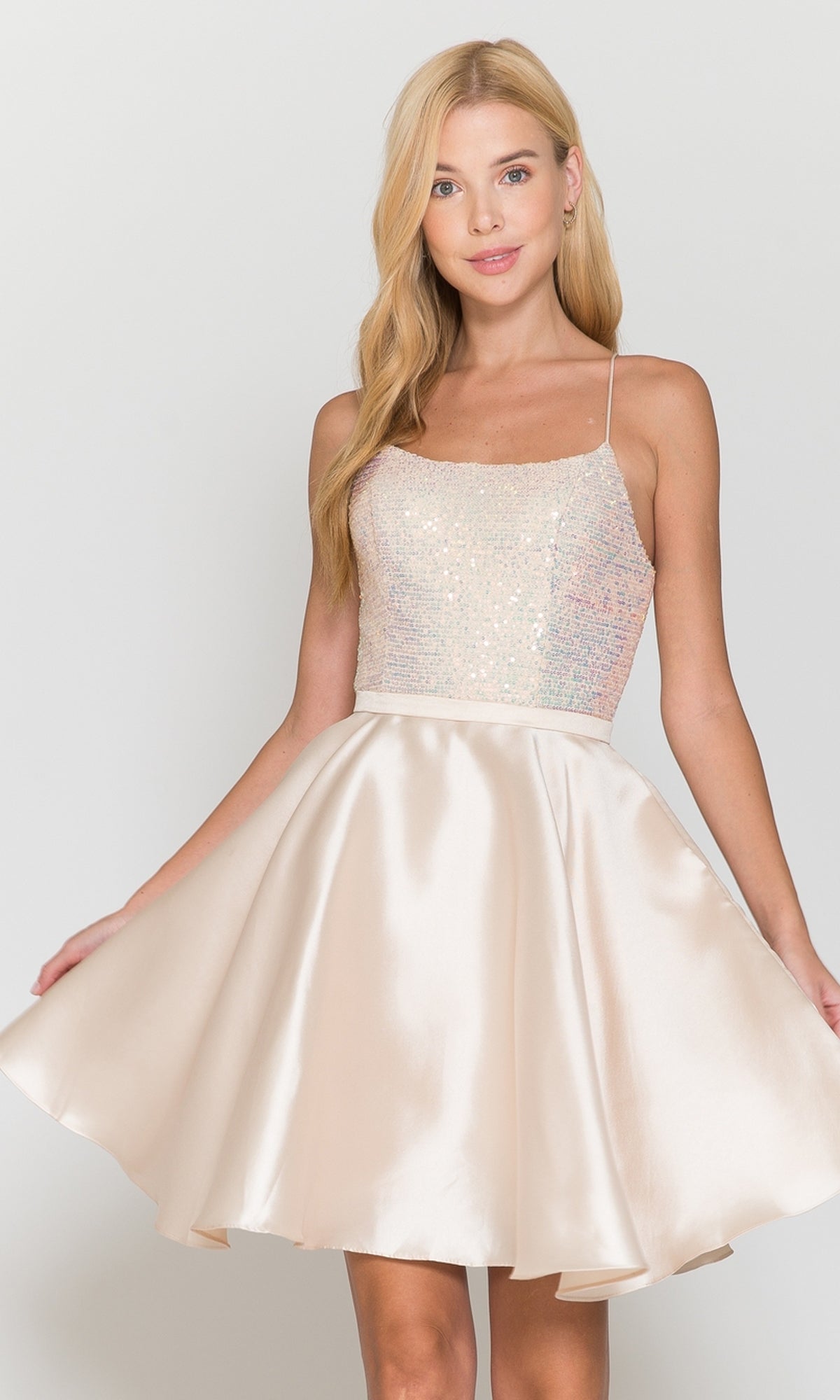 A woman models the Sequin-Bodice Short Flared Homecoming Dress 8730 in royal, featuring a sleeveless sequin bodice and satin flared skirt—a great short dress choice for homecoming or any special occasion.