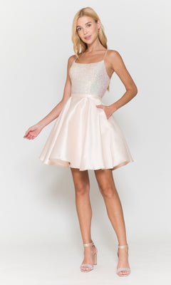 A woman models the Sequin-Bodice Short Flared Homecoming Dress 8730—sleeveless, light pink, with a sparkly bodice and a chic A-line skirt—standing in heels against a white background. Ideal for special events.