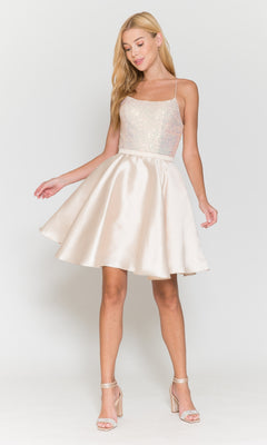 A woman wearing the Sequin-Bodice Short Flared Homecoming Dress 8730, a sleeveless, light-colored party dress with a sequined bodice, A-line silhouette, and flared satin skirt, paired with strappy high-heeled sandals.
