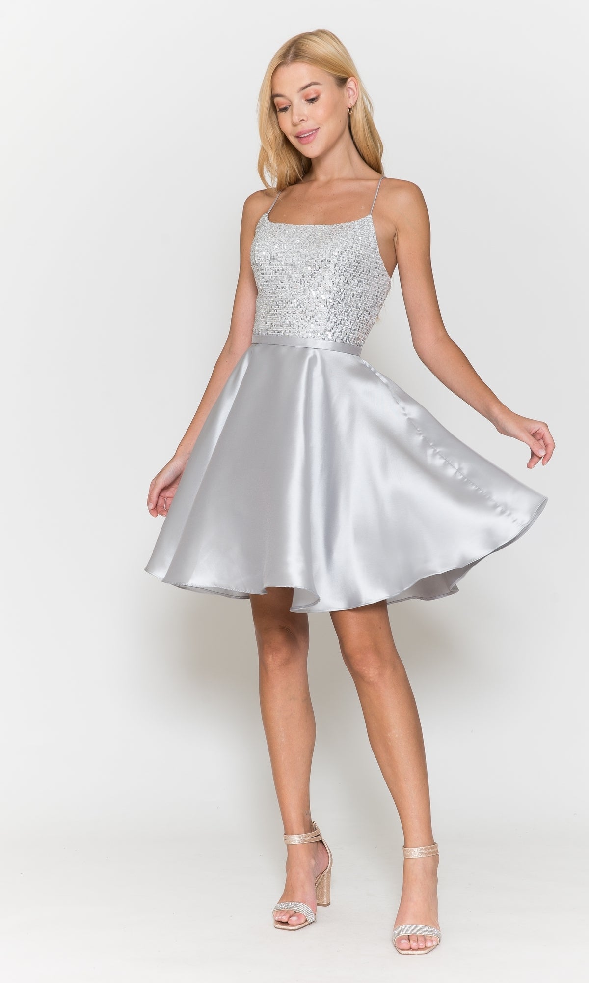 A woman wearing the Sequin-Bodice Short Flared Homecoming Dress 8730 stands against a plain white background.