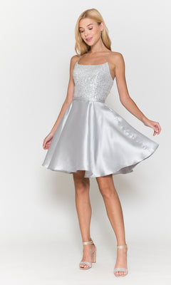 A woman wearing the Sequin-Bodice Short Flared Homecoming Dress 8730 stands against a plain white background.