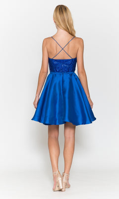 A woman faces away from the camera in the Sequin-Bodice Short Flared Homecoming Dress 8730, a royal blue sleeveless A-line dress with spaghetti straps, paired with nude heels against a plain white background.