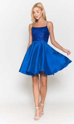A woman models the Sequin-Bodice Short Flared Homecoming Dress 8730, featuring a sleeveless royal blue design with a sequined bodice and an A-line skirt, standing against a white background holding the skirt.