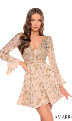 A woman poses with one hand on her hip in the Short Homecoming Dress 88032 by Amarra, a beige mini dress with long sleeves and intricate gold and silver sequin embellishments.