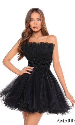 A woman wears the Short Homecoming Dress 88038 by Amarra—a strapless, knee-length black tulle dress with a fitted beaded waist and ruffled skirt.