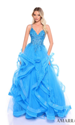 A woman wearing the Amarra 88094 Ruffle Formal Ball Gown with a bright blue embroidered corset bodice, spaghetti straps, and ruffled tulle layers stands against a white background.