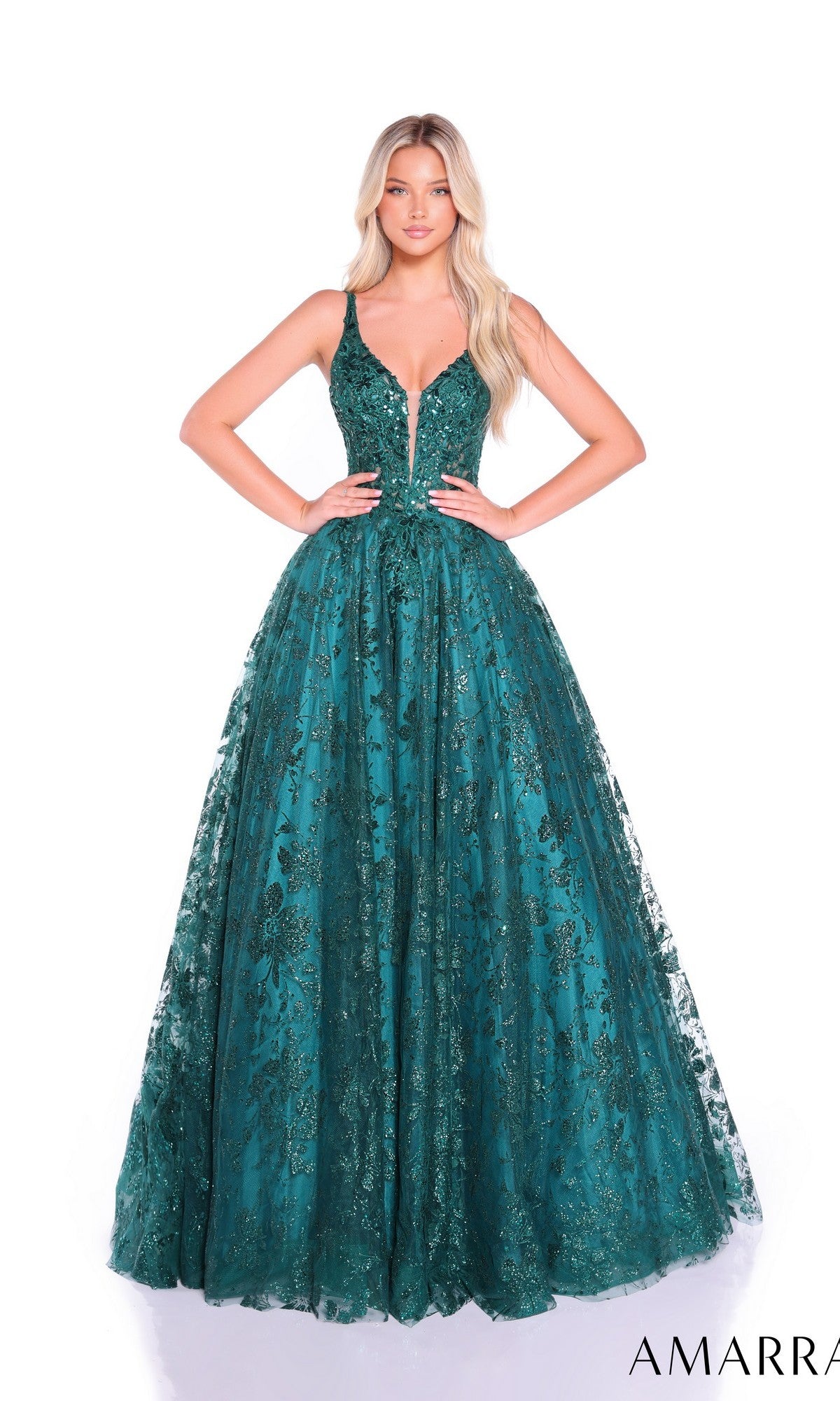 A woman stands against a plain white background wearing the Amarra Long Formal Dress 88126, a deep green sleeveless A-line ball gown featuring a deep V-neckline and intricate lace embellishments.