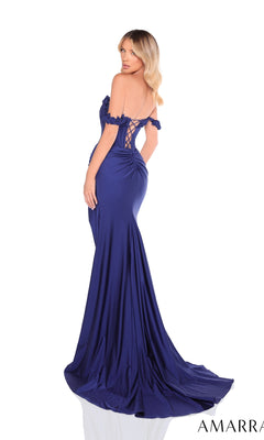 A woman models the Amarra 88225 long prom dress, featuring a fitted, off-the-shoulder design in royal blue with a lace-up back, as she stands and looks over her shoulder.