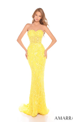 A woman stands against a white background wearing the Amarra 88236, a strapless yellow long prom dress with floral embellishments, corset bodice, slight train, and a fitted silhouette reminiscent of a mermaid gown.