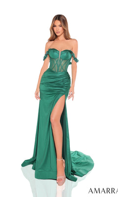 A woman models the Amarra 88243, a long prom dress featuring a strapless fitted emerald green design with a sheer corset bodice, high-leg slit, and floor-length skirt.