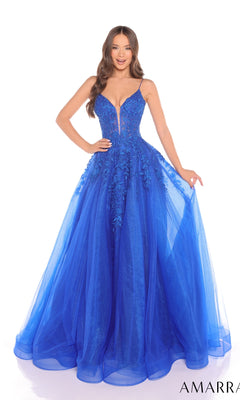 A woman smiles in the Amarra 88245 long prom dress, featuring a bright blue hue, deep V neckline, floral lace embroidery, and a sheer tulle A-line skirt.