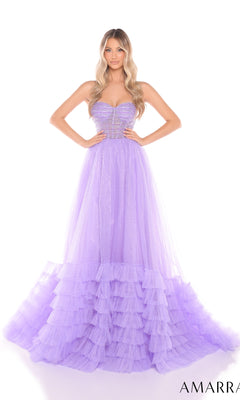 A woman stands against a white background wearing the Amarra 88277 Strapless Prom Ball Gown featuring a sweetheart neckline and an A-line ruffled tulle skirt.