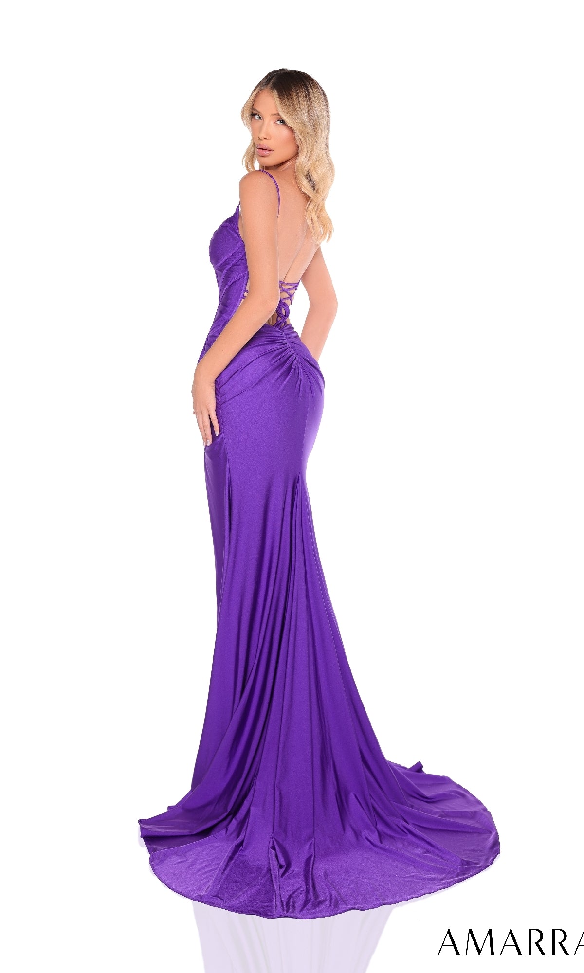 A woman models the Amarra 88326 Long Prom Dress in purple, featuring a fitted jersey design with a corset bodice, thin straps, floor-length skirt, flowing train, and a subtle high-leg slit against a white background.