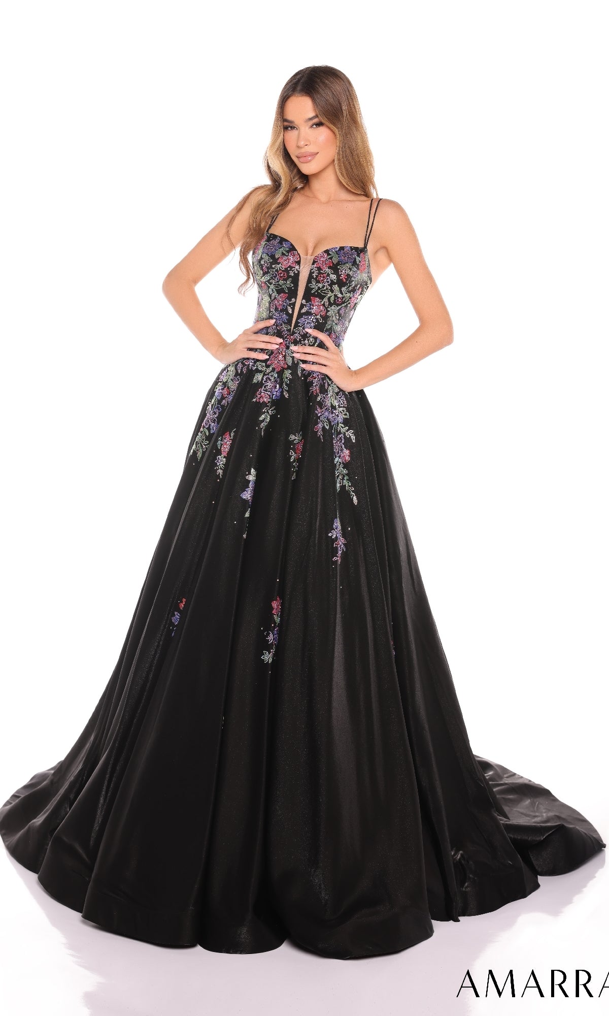 A woman wears the Amarra 88379 long prom dress, featuring a fitted, floral-embroidered bodice with thin straps and a full skirt decorated with delicate floral patterns.