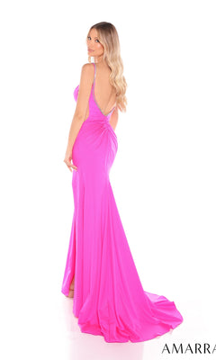 A woman with long blonde hair wears the Amarra 88428, a bright pink, floor-length prom dress with a low back and slight train, standing and looking over her shoulder.