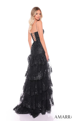 A woman poses gracefully in the Long Formal Dress 88500 by Amarra, featuring black ruffle layers, shimmering sequins, spaghetti straps, a plunging v-neckline, and a lace-up back against a white background.