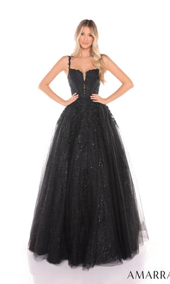 A woman in the Amarra 88590 Floral Lace Prom Ball Gown, featuring black sparkly glitter tulle, thin straps, and a lace-up back, stands with hands on hips against a white background.